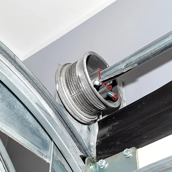 Garage door cable drum on the torsion shaft