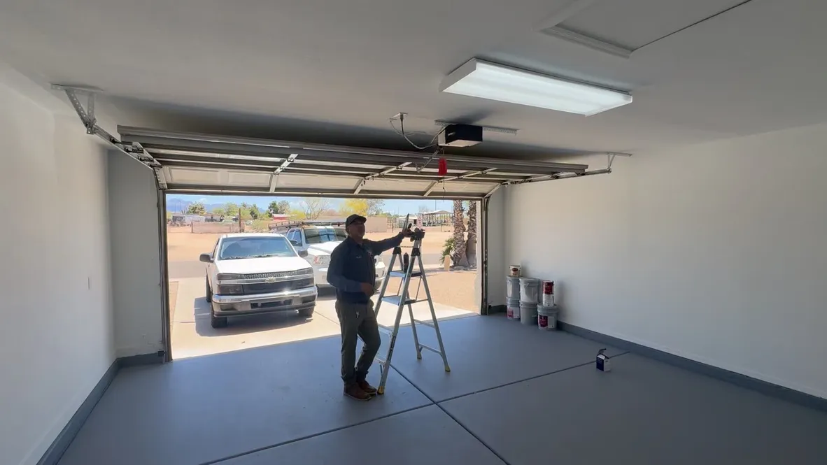 A Plus Garage Doors technician working in a customer's garage