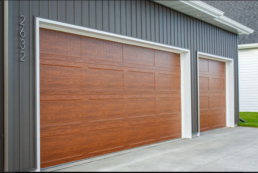 Pair of wood-look garage doors on a gray modern home